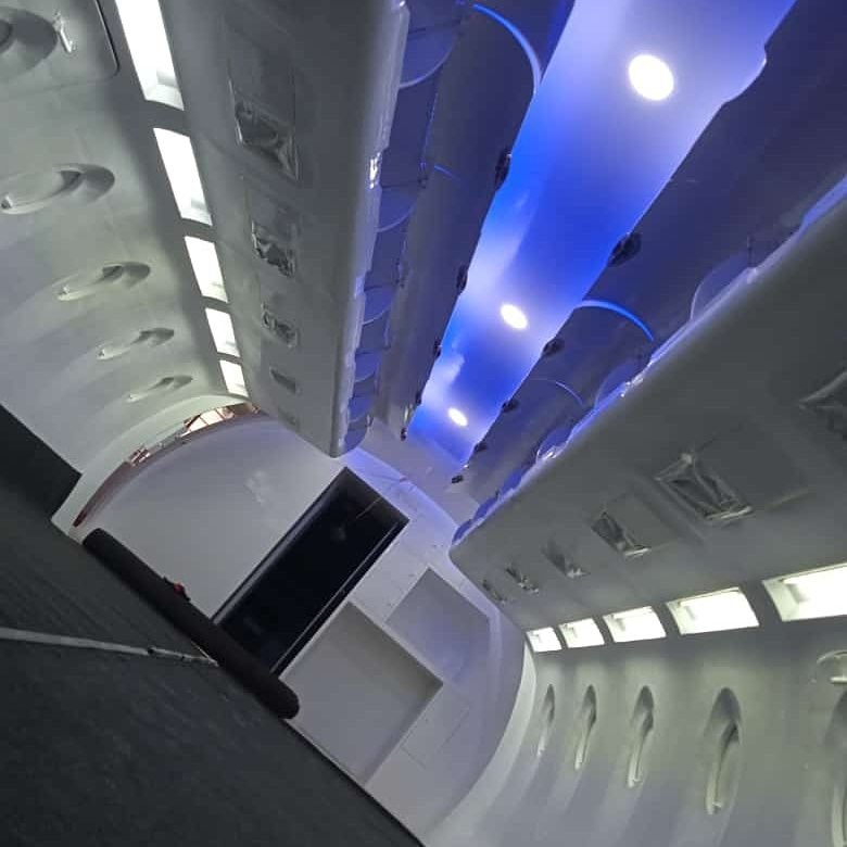 Mood-lit overhead bins and ceiling panel on a cabin trainer