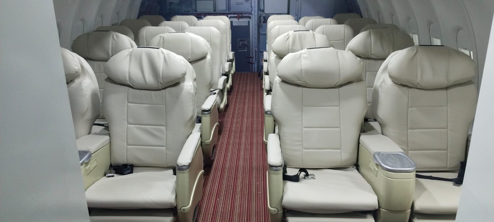 Full aisle view of cream cabin seating